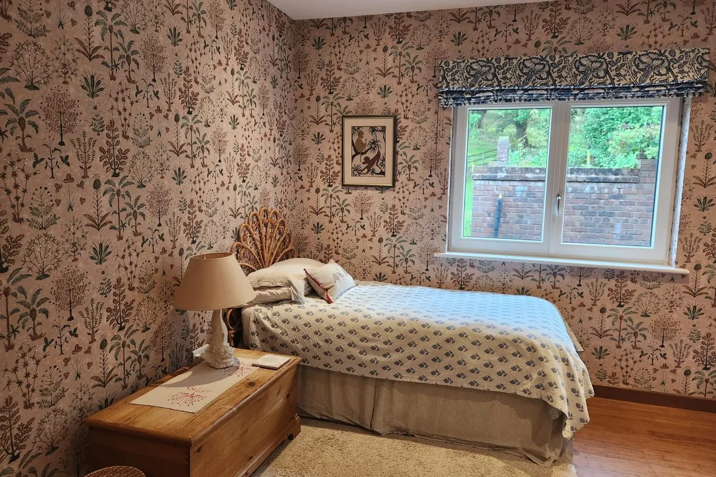 The same bedroom finished in a botanical patterned wallpaper