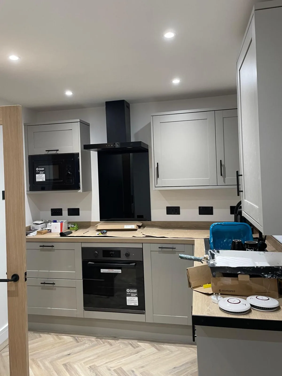 Kitchen refurbishment in progress with new grey units and worktops fitted